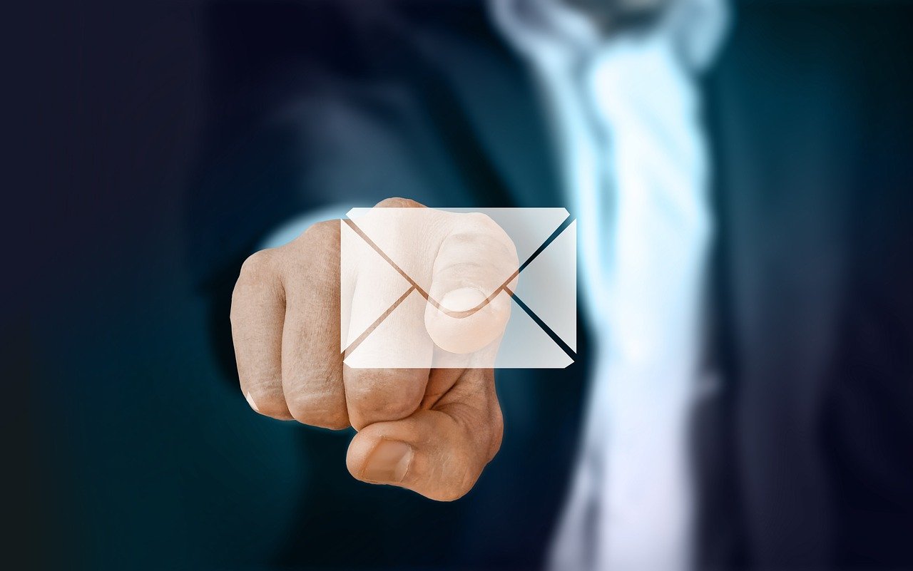 A person in a suit touching an email icon