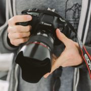 A person holding a camera Description automatically generated with medium confidence